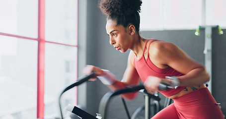 Image showing Exercise bike, cardio and girl cycling for sports fitness, athlete marathon training or high energy body workout. Gym performance motivation, wellness mindset and black woman riding bicycle machine