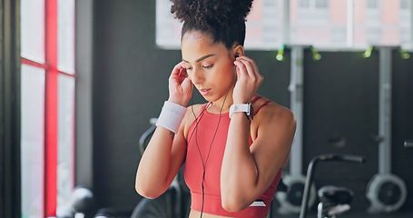 Image showing Black woman, breathe and earphones for music with fitness and exercise ready in gym, health and active motivation. Start, workout and calm for body training and endurance, wellness and listening.