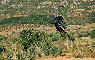 Image showing Jump, extreme sports and mountain bike with man in nature for cycling, fitness and adventure. Adrenaline junkie, performance and stunt with athlete riding in outdoors for action, risk and training