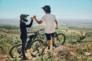 Image showing Fist bump, teamwork and cycling with friends on mountain bike for motivation, extreme sports and adventure. Fitness, workout and bonding with men in nature for adrenaline junkie, freedom and travel