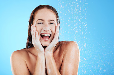 Image showing Woman in shower, happy in portrait with hygiene and water drops, soap and clean with excited face on blue background. Facial, hydration and skincare with female cleaning body, foam and mockup space