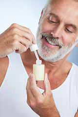 Image showing Beauty, skincare and serum with man in studio for anti aging, cosmetics and spa treatment. Product, facial and essential oil with senior model on gray background for wrinkles, retinol and grooming