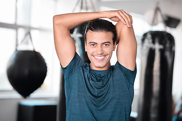 Image showing Portrait, stretching arm and man in gym ready to start workout, training or exercise. Sports smile, health fitness and happy male athlete warm up, stretch or prepare for exercising for flexibility.