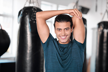 Image showing Portrait, stretching arm and man in gym ready to start workout, training or exercise. Sports smile, health fitness and happy male athlete warm up, stretch or prepare for exercising for flexibility.