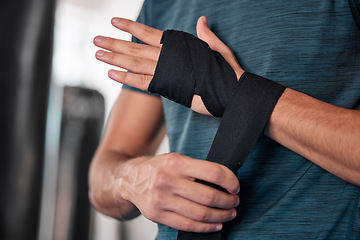 Image showing Man wrapping hand, boxing and fitness with martial arts in gym, exercise and power with strong person. Workout, male boxer training in combat and sport, athlete ready to fight and closeup of hands