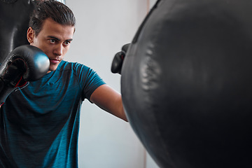 Image showing Sports, boxing and man with punching bag in gym for training, exercise or workout. Boxer, athlete and male fighter punch for fight, competition or practice match, health and wellness for strength.