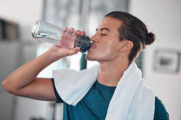 Image showing Fitness, man and drinking water for hydration after workout, exercise or intense training at home. Thirsty male resting from sports exercising for hydrated wellness, health and fresh natural drink