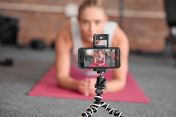 Image showing Live streaming, fitness and phone of woman exercise, pilates or workout on social media or video platform on tripod. Gen z athlete, sports influencer or content creator training on smartphone screen