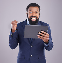 Image showing Winning, tablet and black man isolated on gray background portrait for stock market, trading or business bonus or success. Yes, fist pump and person or winner, sales profit and digital tech in studio