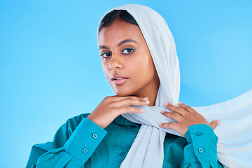 Image showing Woman, muslim and portrait of hijab in studio, blue background or color backdrop. Young female model, islamic culture or scarf for peace, religion and arabic fashion of eid mubarak, beauty or ramadan