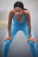 Image showing Tired, fitness and breathing woman for outdoor cardio training, workout and sports running break in mist or fog. Focus, thinking and serious runner person with exercise goals and challenge in street