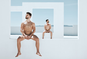 Image showing Art, pose and naked men sitting in creative architecture, sun and blue sky, muscle and athletic lgbt body. Pride, gay models posing as nude Greek athlete in and freedom in artistic self expression.