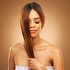 Image showing Haircare, studio and woman with hair in hand, strong with bronze texture and salon shine. Wellness model, mockup and spa beauty, healthy straight hairstyle with keratin product on brown background.