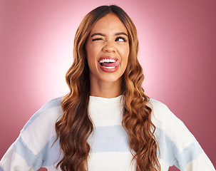 Image showing Funny, face and goofy woman tongue out feeling happy, playful and excited isolated in a studio purple background. Comic, joke and head of a young and crazy female wink for humor or happiness