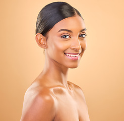 Image showing Smile, glowing and portrait skincare of a woman isolated on a studio background. Happy, beautiful and an Indian model with a glow from cosmetics, healthy skin and smooth complexion on a backdrop