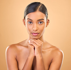 Image showing Face, beauty and portrait of woman in studio for skincare, cosmetics, dermatology or makeup. Aesthetic female .serious about self care, natural skin and spa facial shine results on a brown background