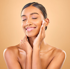 Image showing Beauty, hands on face and skin of woman in studio for happy glow, cosmetics, dermatology or makeup. Aesthetic female smile for self care, natural shine and spa facial results on a brown background