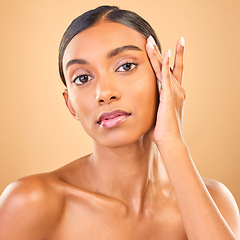 Image showing Skincare, face portrait and beauty of woman in studio isolated on brown background. Makeup, serious cosmetics and confident Indian female model with spa facial treatment for healthy or flawless skin.