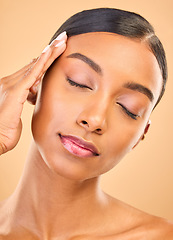 Image showing Beauty, hand on face and makeup of woman in studio for skincare, cosmetics or dermatology. Aesthetic female for self care, natural skin and spa facial shine or glow results on a brown background