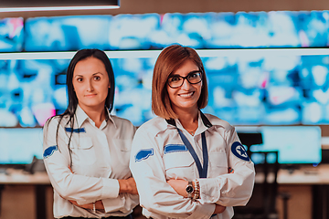 Image showing Group portrait of female security operator while working in a data system control room offices Technical Operator Working at workstation with multiple displays