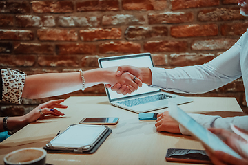 Image showing Business shaking hands, finishing up meeting. Successful businesspeople handshaking after good deal