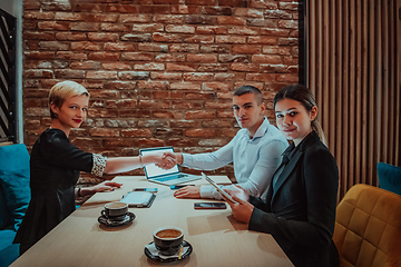 Image showing Business shaking hands, finishing up meeting. Successful businesspeople handshaking after good deal