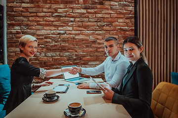 Image showing Business shaking hands, finishing up meeting. Successful businesspeople handshaking after good deal