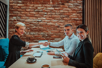 Image showing Business shaking hands, finishing up meeting. Successful businesspeople handshaking after good deal