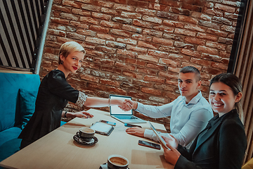 Image showing Business shaking hands, finishing up meeting. Successful businesspeople handshaking after good deal