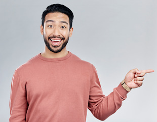 Image showing Excited, gesture and portrait of Indian man pointing at mockup and product placement isolated on white background. Promotion, information and person showing deal space in studio with launch idea.