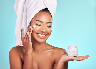 Image showing Skincare, lotion and black woman with jar, cream for anti aging and fresh skin glow on blue background. Cosmetics, facial and African model with moisturizer or cleansing product in hand in studio.