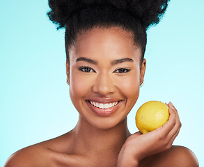 Image showing Lemon, skincare beauty and woman portrait of facial, wellness and detox healthcare. Isolated, blue background and studio with a young female feeling happy from healthy food with vitamin c for glow