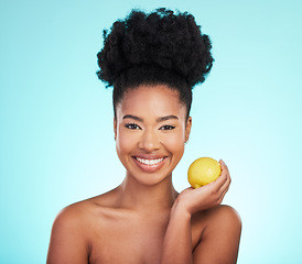 Image showing Lemon beauty, portrait and happy black woman in studio, blue background and vegan wellness. Happy model, citrus fruits and smile for facial cosmetics, vitamin c skincare and natural detox dermatology