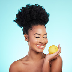 Image showing Lemon, skincare happiness and woman with beauty, wellness and detox healthcare. Isolated, blue background and studio with a young female feeling happy from healthy food with vitamin c for glow
