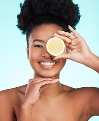 Image showing Black woman, face and smile with lemon for skincare nutrition, beauty or vitamin C against studio background. Portrait of African American female smiling with fruit for natural health and wellness