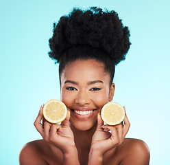 Image showing Lemon, portrait and beauty of happy black woman in studio, blue background or vegan wellness. Happy model, citrus fruits and smile of facial cosmetics, vitamin c skincare or natural detox dermatology