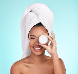 Image showing Black woman, jar and skin cream in studio portrait with smile for skincare, wellness or self care by blue background. Girl, african and model with product by eye for natural glow, beauty or cosmetics