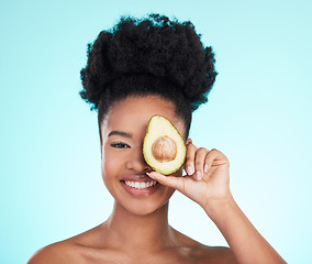 Image showing Avocado, happy skincare and woman portrait of beauty, wellness and detox healthcare. Isolated, blue background and studio with a young female smile from healthy fruit food with vitamin for glow