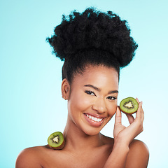Image showing Kiwi fruit, skincare and woman portrait of beauty, wellness and detox healthcare. Isolated, blue background and studio with a young female feeling happy from healthy food with vitamin c for glow