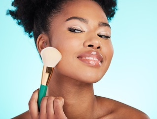 Image showing Makeup, brush and face of black woman for beauty, cosmetics and facial treatment on blue background. Salon, cosmetology and happy girl with brushes for foundation, skincare and application in studio