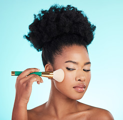 Image showing Makeup, cosmetics brush and face of black woman for beauty, glamour and facial treatment on blue background. Salon, cosmetology and girl with brushes for foundation, skincare or application in studio