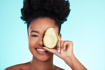 Image showing Avocado, woman smile and portrait of a young model with skincare, fruit and wellness for diet. Isolated, blue background and studio with a person with beauty, cosmetics and healthy food for skin glow