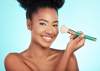 Image showing Black woman, brush and makeup in studio with smile for wellness, cosmetics or youth by blue background. Model, girl and african with foundation, powder and happy for skincare, beauty and healthy glow