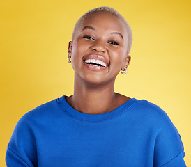 Image showing Black woman, smile and face portrait in studio for motivation, beauty and happiness and mindset. Young african aesthetic female model on a yellow background laughing for cosmetics and positive color