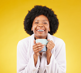 Image showing Bathrobe, coffee and portrait of happy black woman in studio, waking up in the morning and smile on yellow background. Face, relax and isolated female with tea, satisfied with stress relief