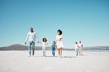 Image showing Holding hands, family and children walking on beach to relax on summer holiday, vacation and weekend. Travel, blue sky and grandparents, parents and kids by ocean for fun, bonding and quality time