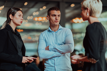 Image showing Photo of a business team of young people discussing business ideas in a modern urban environment. Selective focus