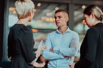 Image showing Photo of a business team of young people discussing business ideas in a modern urban environment. Selective focus