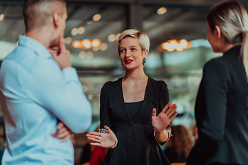 Image showing Photo of a business team of young people discussing business ideas in a modern urban environment. Selective focus