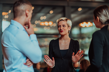 Image showing Photo of a business team of young people discussing business ideas in a modern urban environment. Selective focus